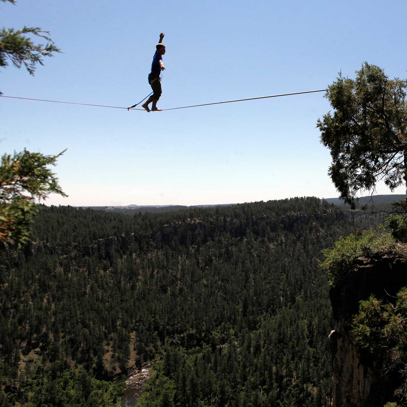 A person walks on a zip line in the Black Hills taken by Chris Huber.